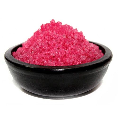 Small pink scented simmering granules for use in a traditional oil burner to fragrance a room.