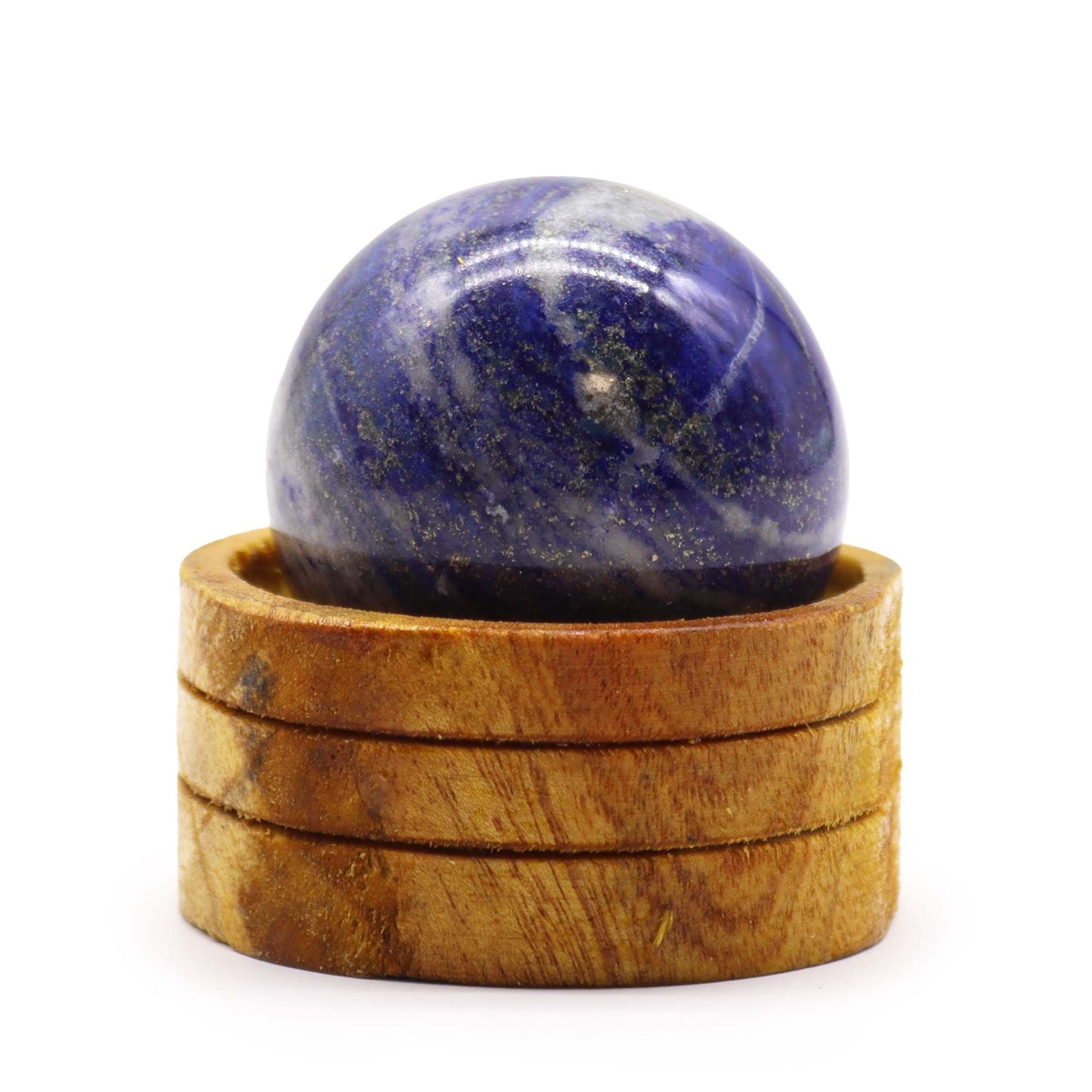 Deep blue Afghan Lapis Lazuli crystal sphere with golden pyrite flecks resting on a simple wooden stand.
