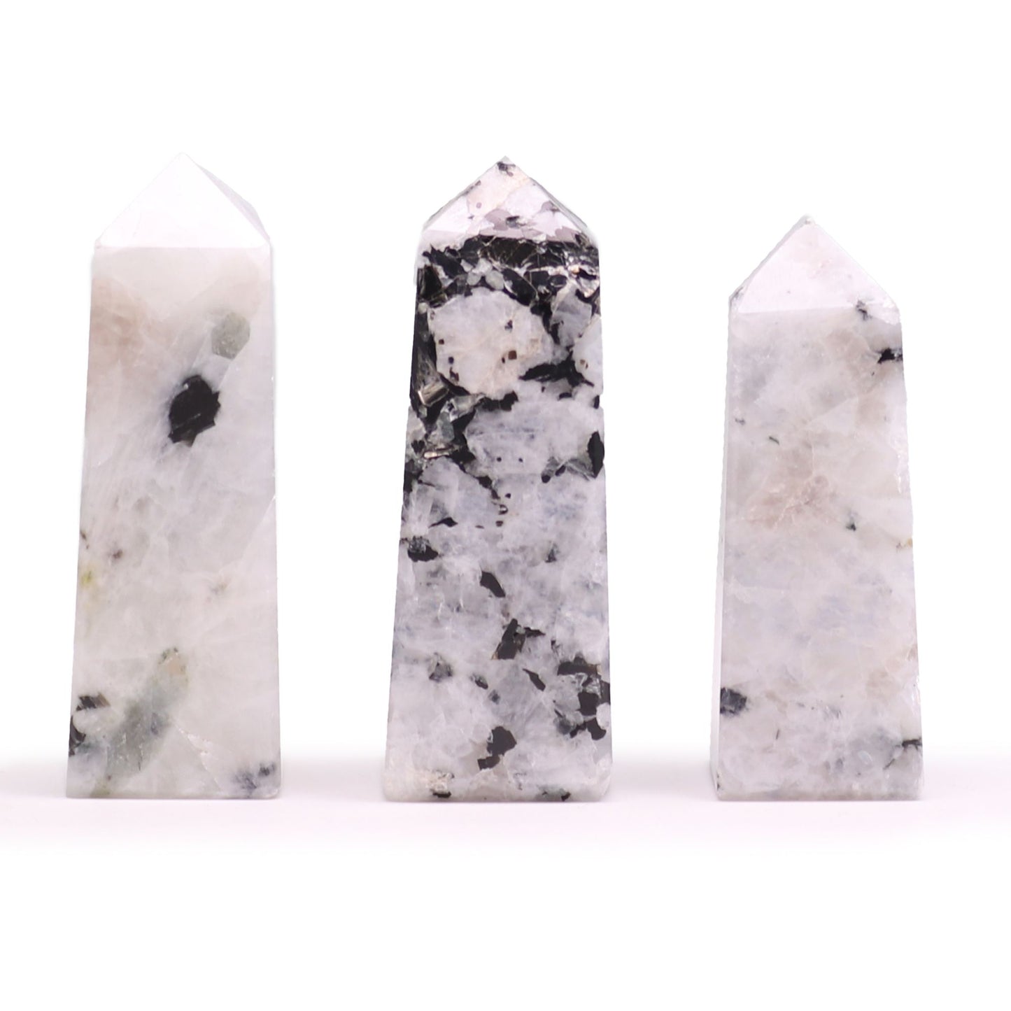 A smooth, polished moonstone obelisk point standing upright, showing natural iridescent gemstone textures.
