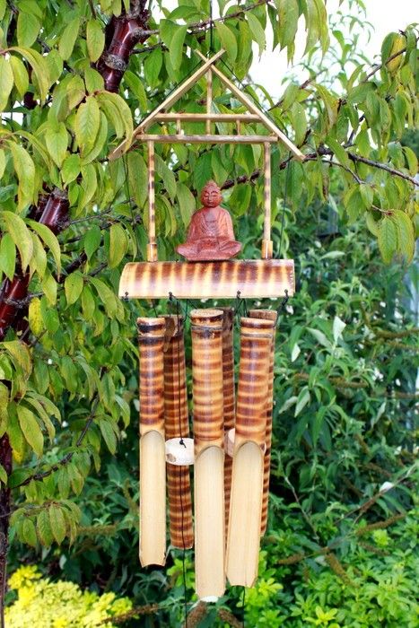 Six-tube natural bamboo wind chime with a small Buddha figure accent hanging from a wooden top.