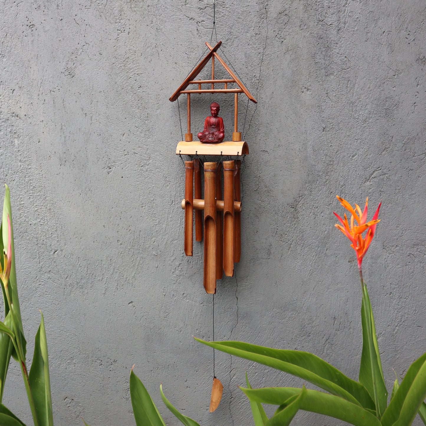 Handcrafted natural bamboo windchime with a brown Buddha motif and six melodic wooden tubes.