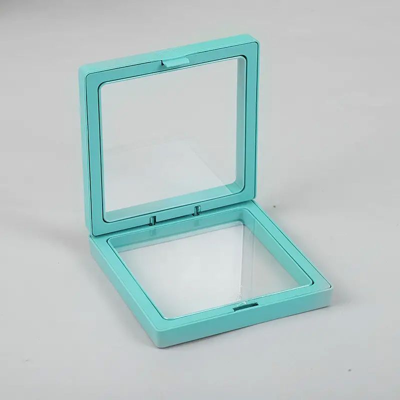 Square teal 3D floating frame display with a clear flexible membrane showing a suspended object effect.