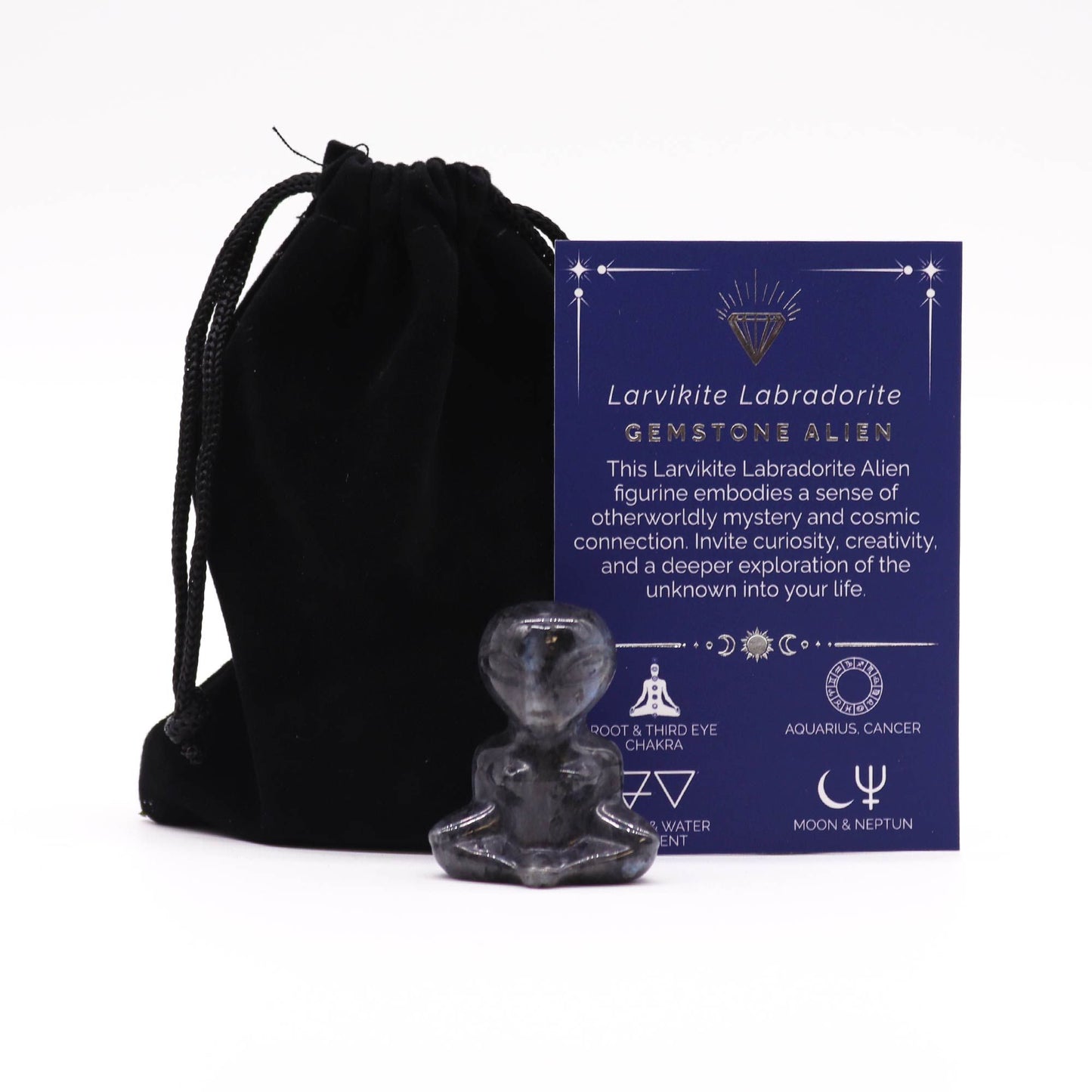 A hand-carved alien figurine made from shimmering grey Larvikite Labradorite gemstone with subtle flash.