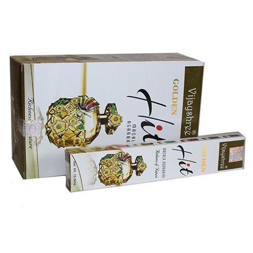Hand-rolled masala incense sticks with a golden hue, displayed in a simple wooden burner.