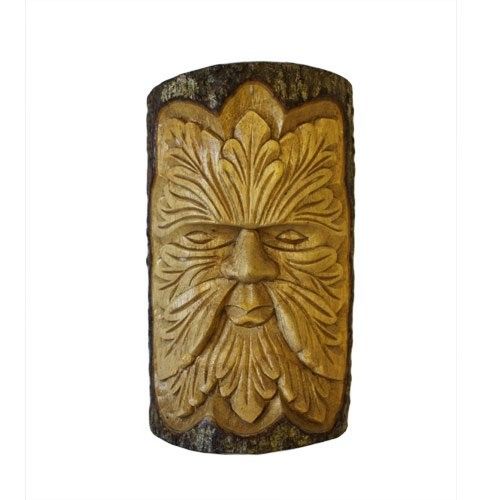 Detailed wood carving of a Green Man face with leafy features, fashioned from a natural tree stump section.