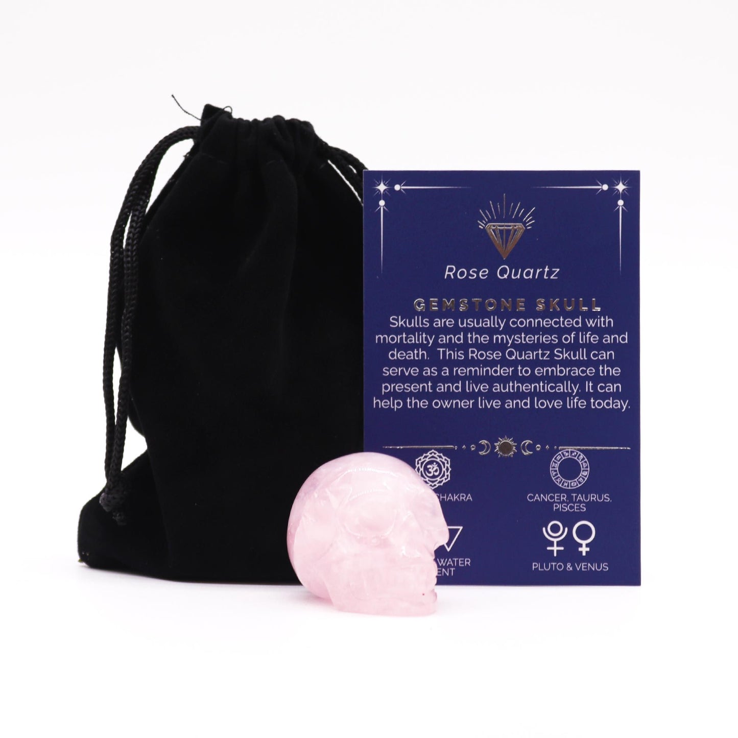 A small, polished pink rose quartz gemstone carved into the shape of a realistic human skull.