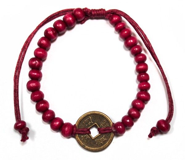 Adjustable red cord bracelet featuring dark wood beads and a traditional Chinese fortune coin for good luck.