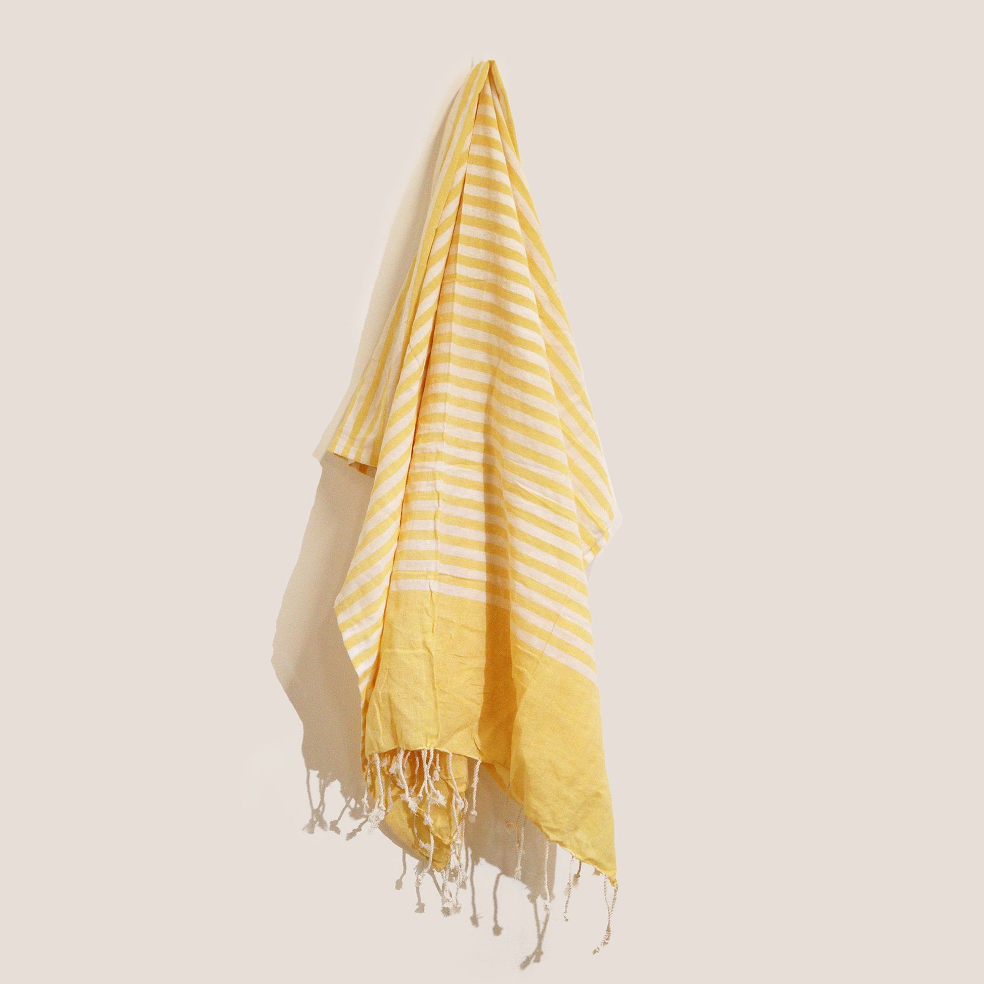 Handcrafted sunny yellow cotton pareo throw with a soft texture and delicate fringe edge detail.
