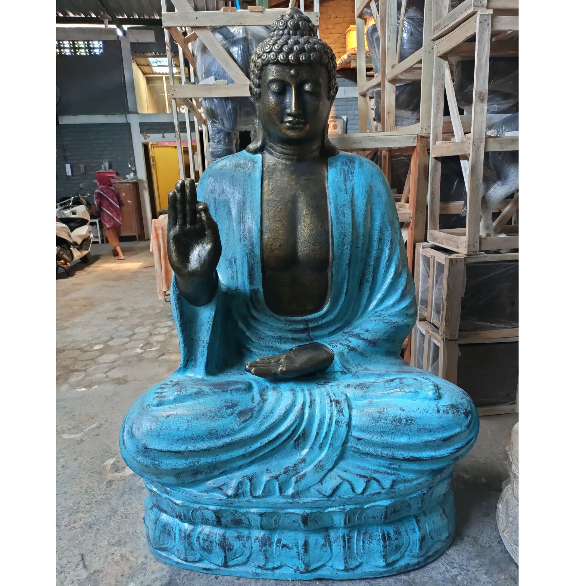 Magnificent 2m tall turquoise and stone Buddha statue in a teaching mudra pose seated upon a lotus base.