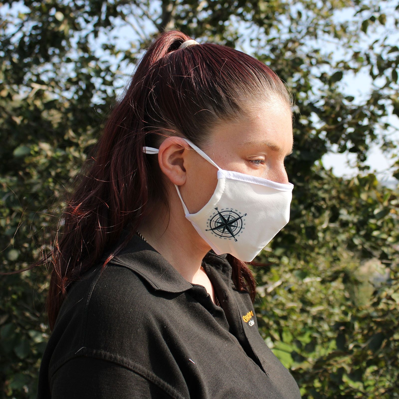 Adult-sized reusable fabric face mask featuring a classic nautical compass design on a dark background.