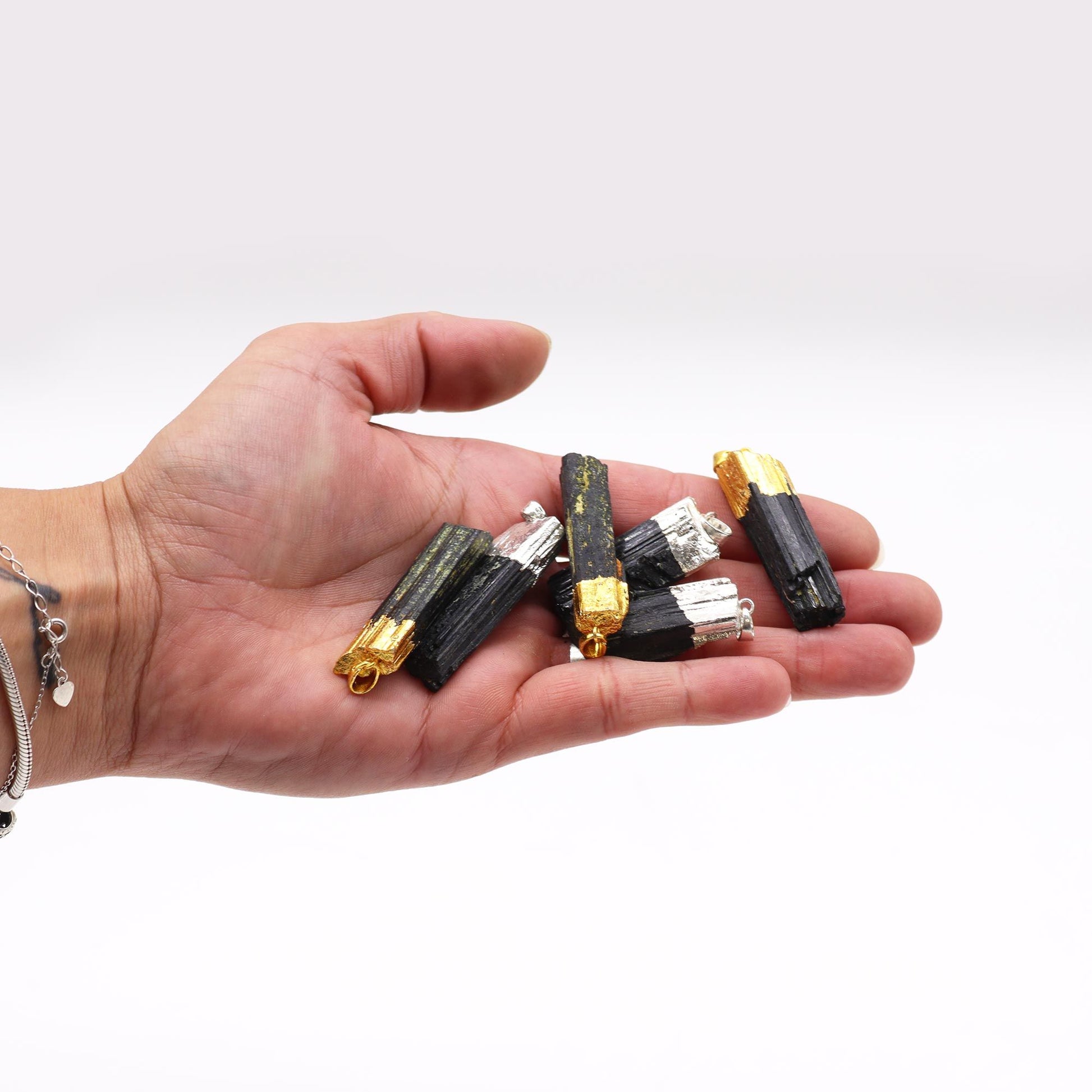 Six assorted raw Indian tourmaline gemstone pendants with elegant silver-plated bails and wire wrapping.