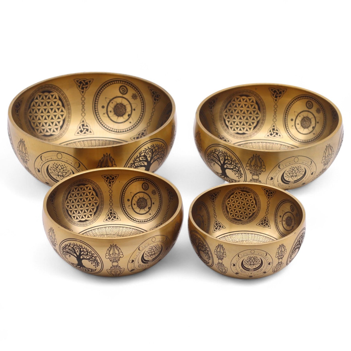 Set of four handcrafted brass singing bowls with intricate Buddha, lotus, and mandala etchings.