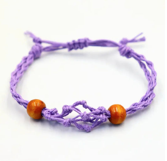 Purple adjustable cord bracelet with a delicate net-like design and two small wooden beads.