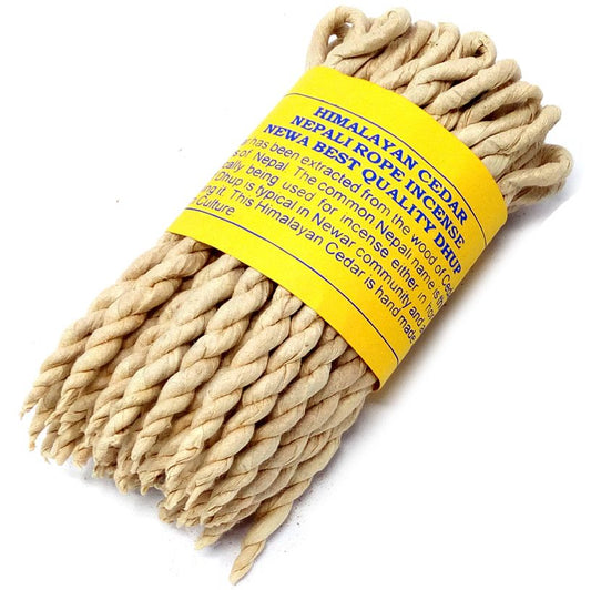 Hand-rolled Himalayan cedar rope incense bundle on a neutral background.