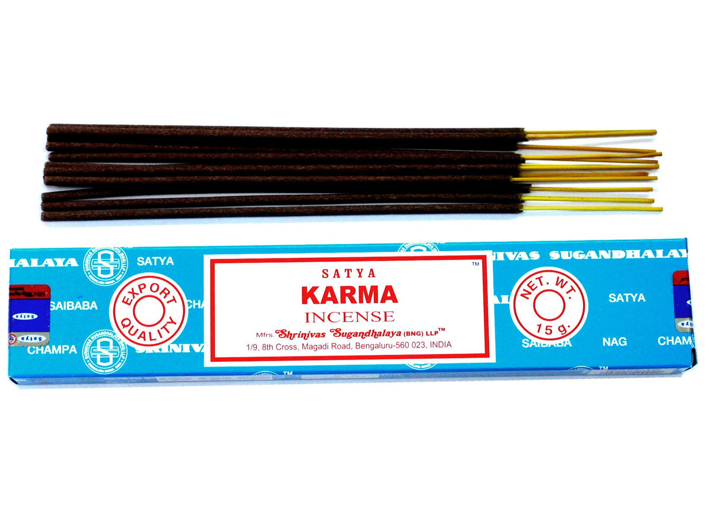 Hand-rolled incense sticks in a blue box with a sunburst design, releasing a gentle trail of aromatic smoke.