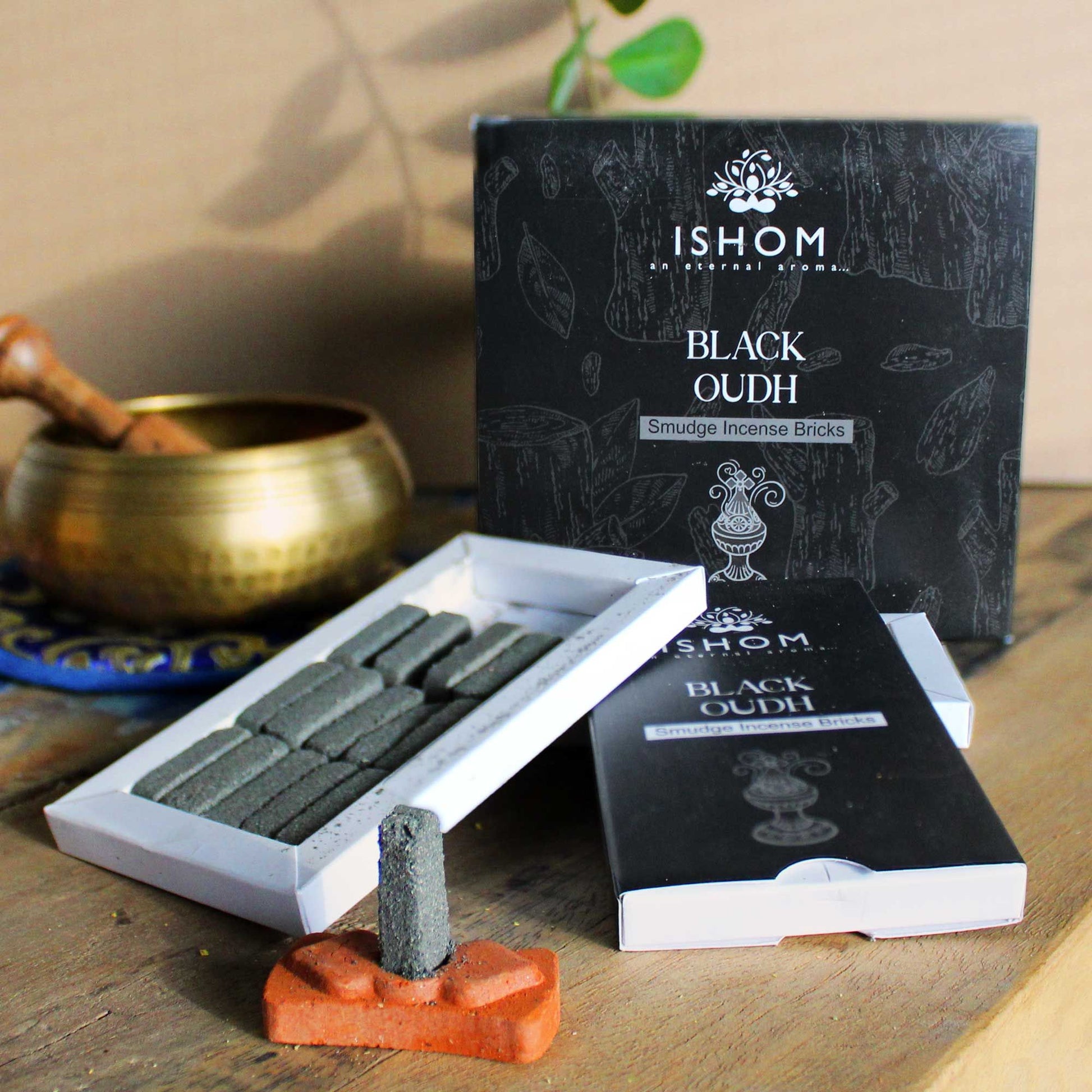 Pack of fifteen dark natural incense smudge bricks arranged next to a traditional round terracotta burner bowl.