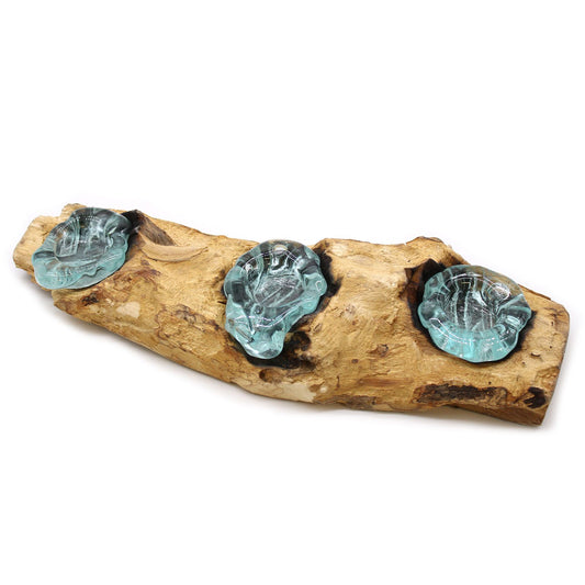 Three molten glass bowls fused onto a flat natural wood base, designed for use as candle holders.