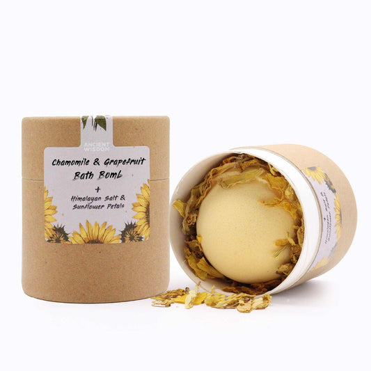 Artisanal bath bomb set with vibrant yellow sunflower petals and mineral-rich pink Himalayan bath salts in a gift box.