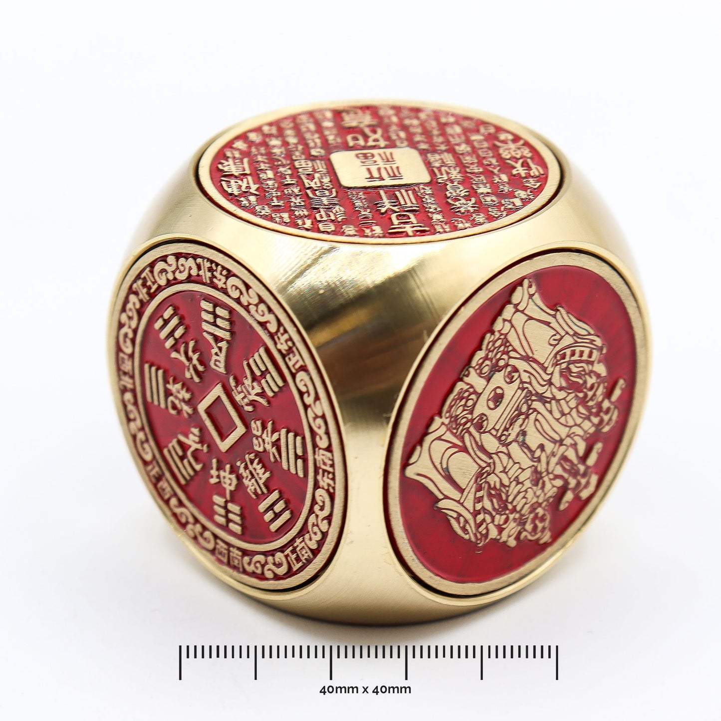 Spinning prosperity cube in bold red and brass with traditional engraved symbols of fortune and wealth.