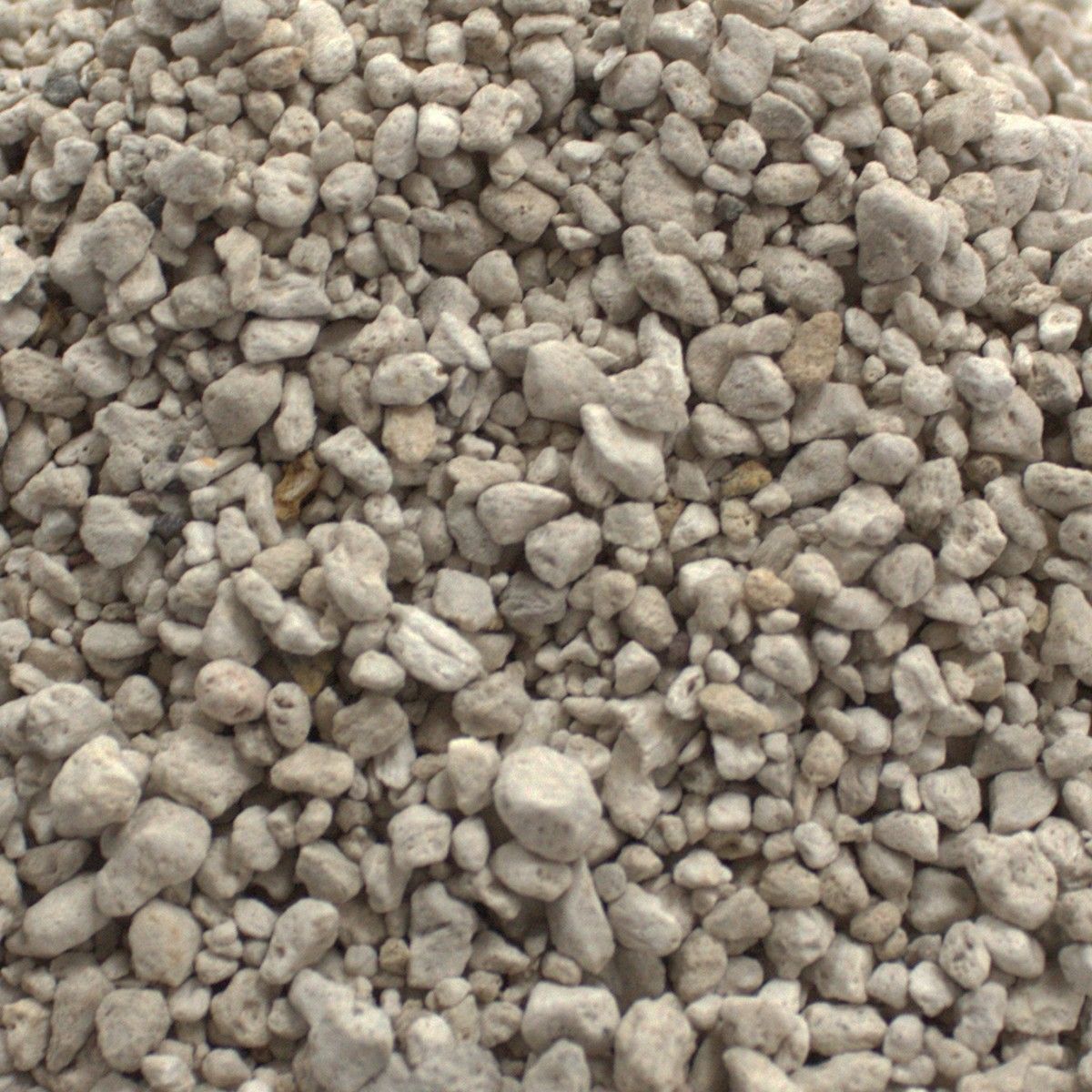 Large eco-friendly jute bag filled with small, grey-toned fine pumice stones for natural skin exfoliation.