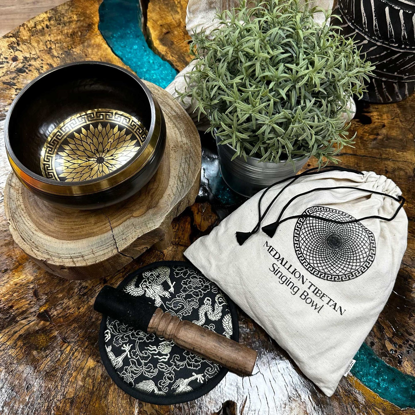 Handcrafted 14cm singing bowl with intricate round medallion engravings, wooden mallet, and plush cushion in a gift set.