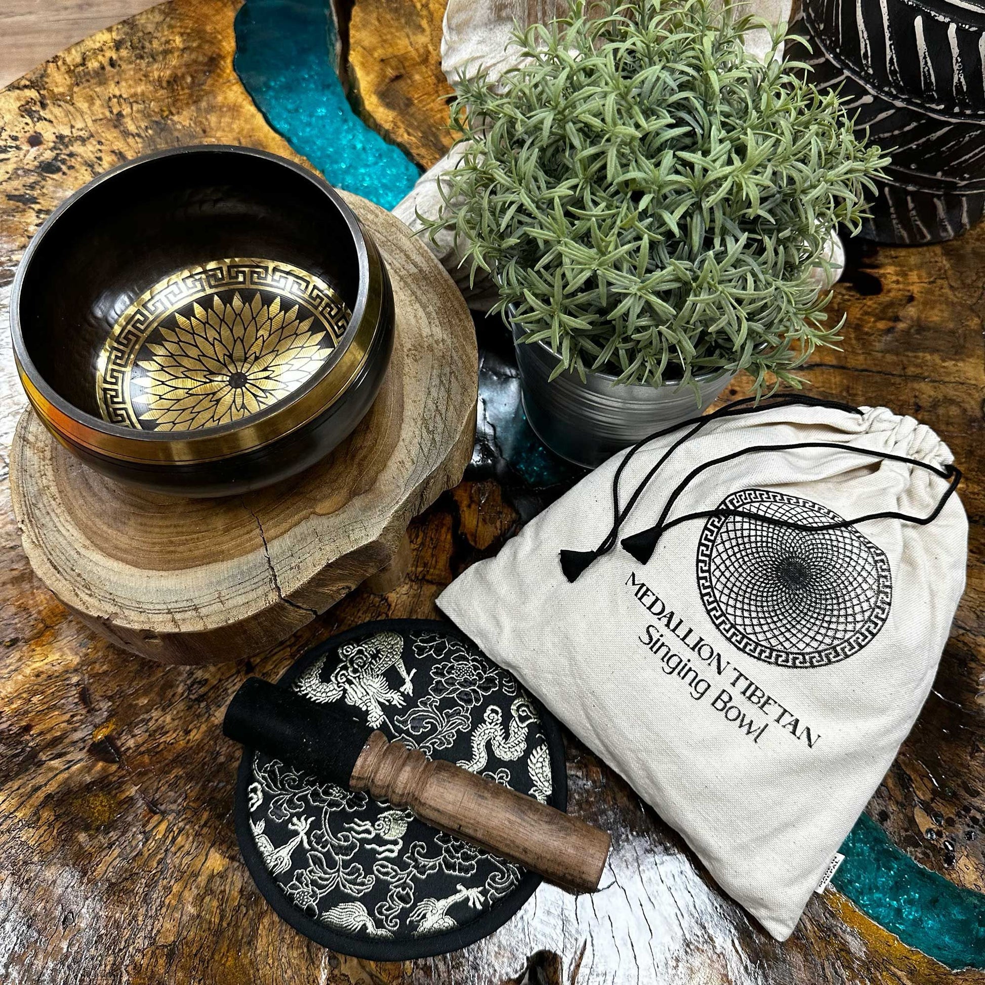 Handcrafted 14cm singing bowl with intricate round medallion engravings, wooden mallet, and plush cushion in a gift set.