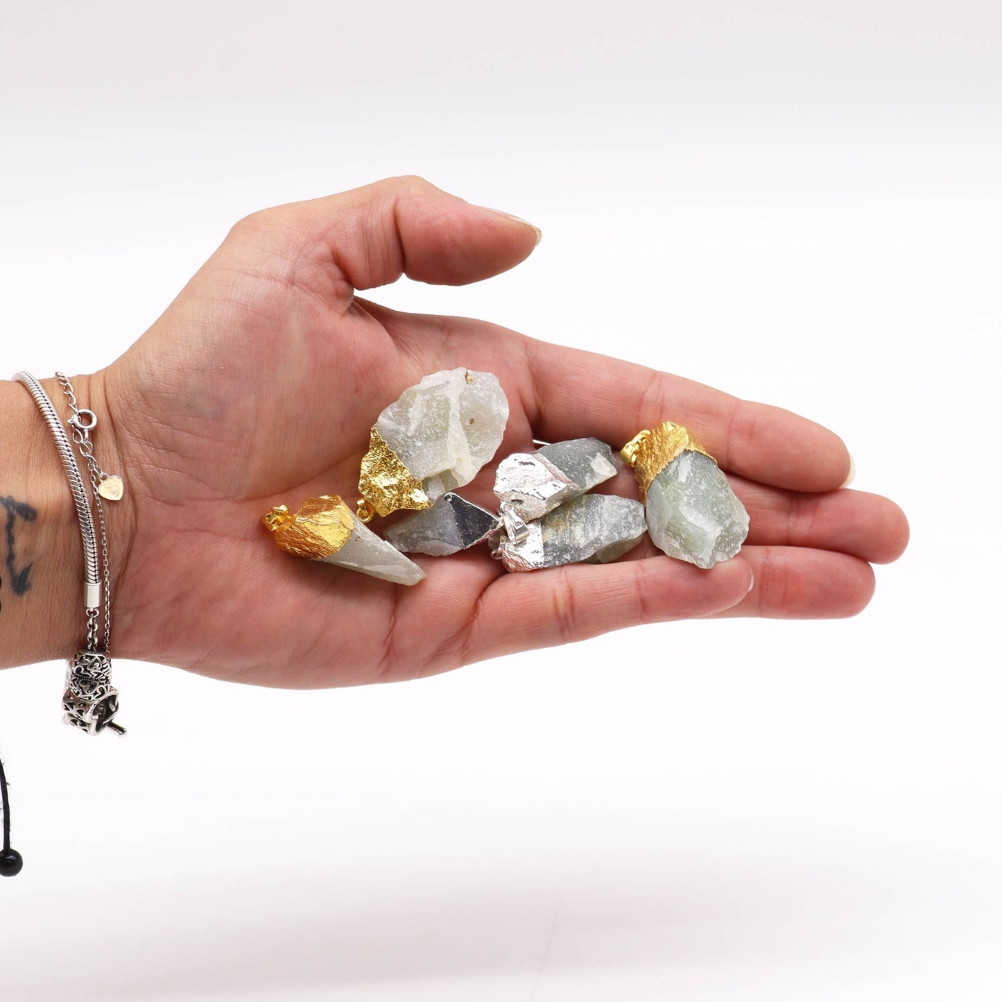 Assorted green Indian Jade gemstone pendants with decorative gold and silver plated settings.