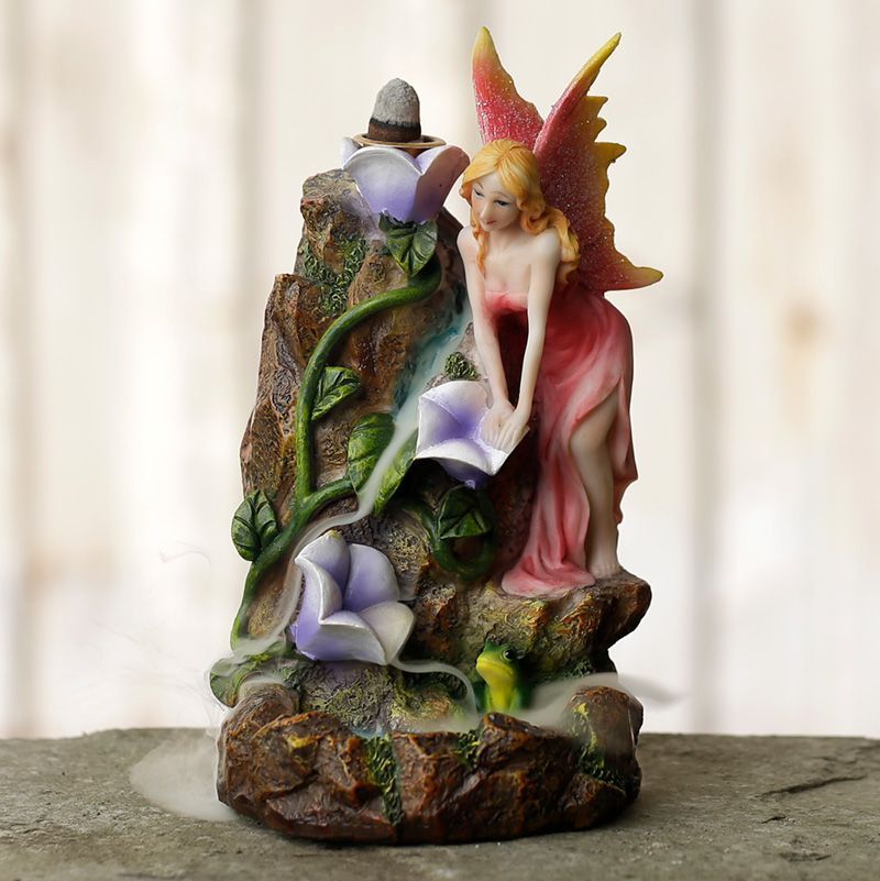Intricate resin backflow incense burner featuring a fairy flower garden with a cascading smoke waterfall effect.