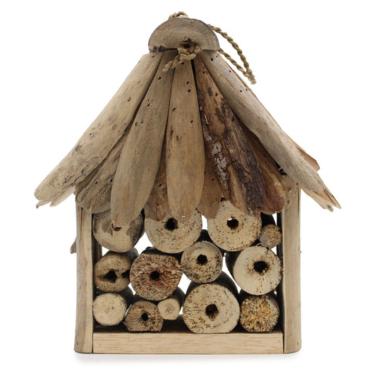 Handcrafted garden insect house made from natural recycled driftwood pieces with various nesting holes.