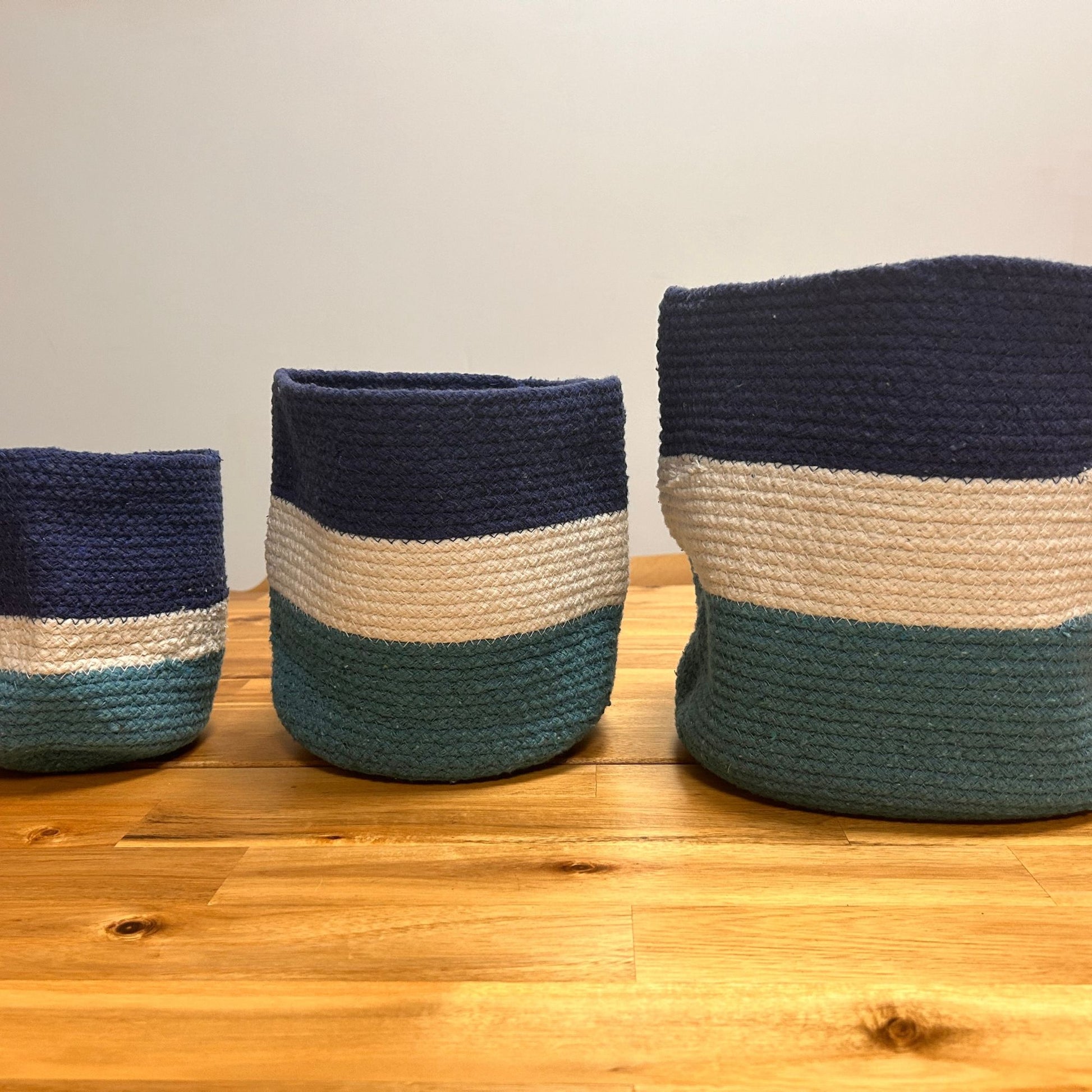 Set of three nesting jute rope storage baskets with blue, white, and teal stripes inspired by the Evil Eye symbol.