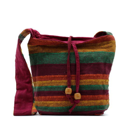 Handcrafted Nepal sling bag with a Mountain Trek pattern in earth-toned tan and green shades featuring a zip closure.