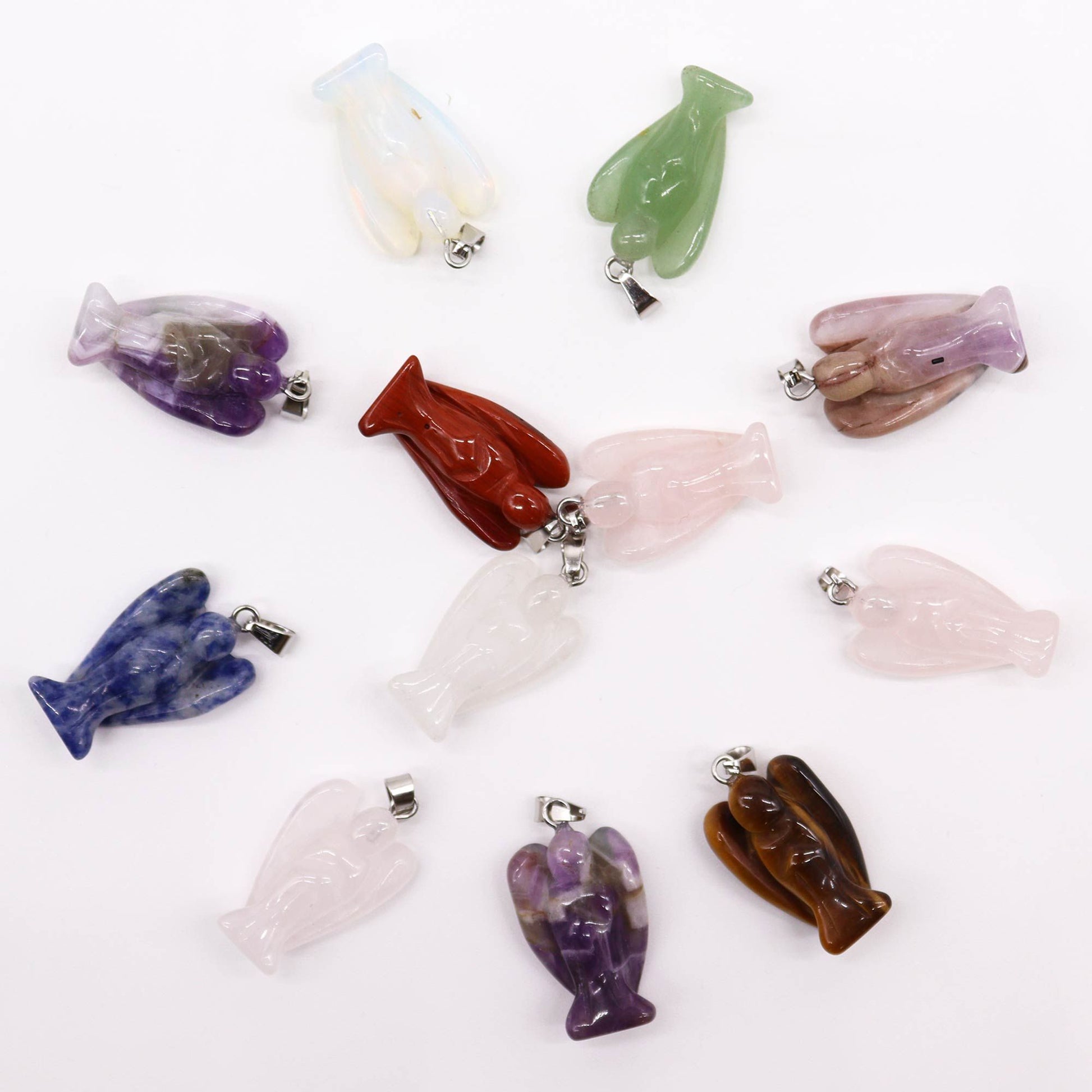 Twelve assorted colourful gemstone mini angel pendants arranged together showing various natural crystal textures.