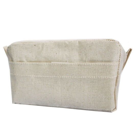Cream-coloured natural organic cotton toiletry bag with a top zip and front pocket.