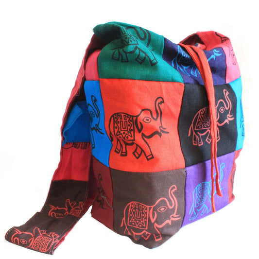 Vibrant cotton patchwork sling bag featuring a detailed elephant motif and a wide comfortable shoulder strap.