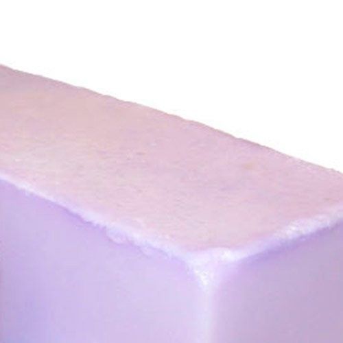 Large artisanal soap loaf scented with fig and cassis, displaying a rich textured surface.