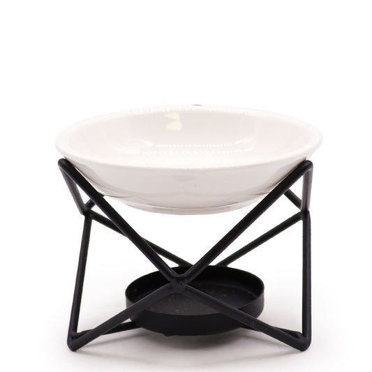 Modern hexagonal oil burner featuring a white ceramic bowl suspended in a geometric black metal frame.