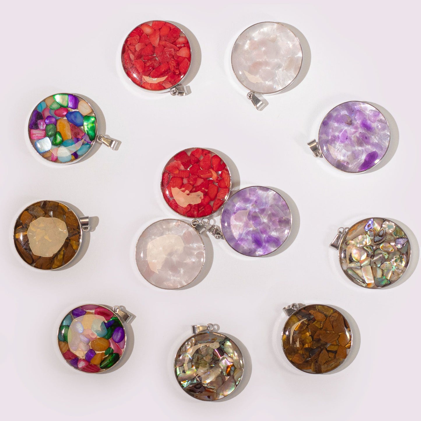 Round steel-cased pendant filled with colourful assorted gemstone chips and delicate natural shells.