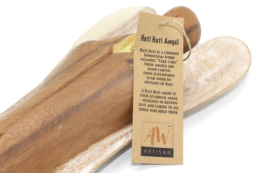 Small hand-carved wooden angel statue with hands held to the heart, representing love and compassion.