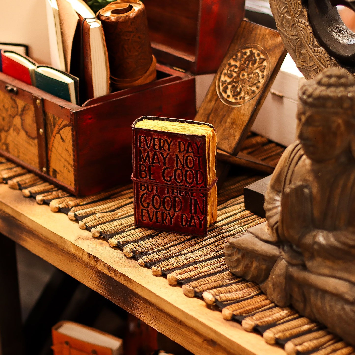 Small brown leather journal with embossed quote and thick handmade deckled-edge paper pages.
