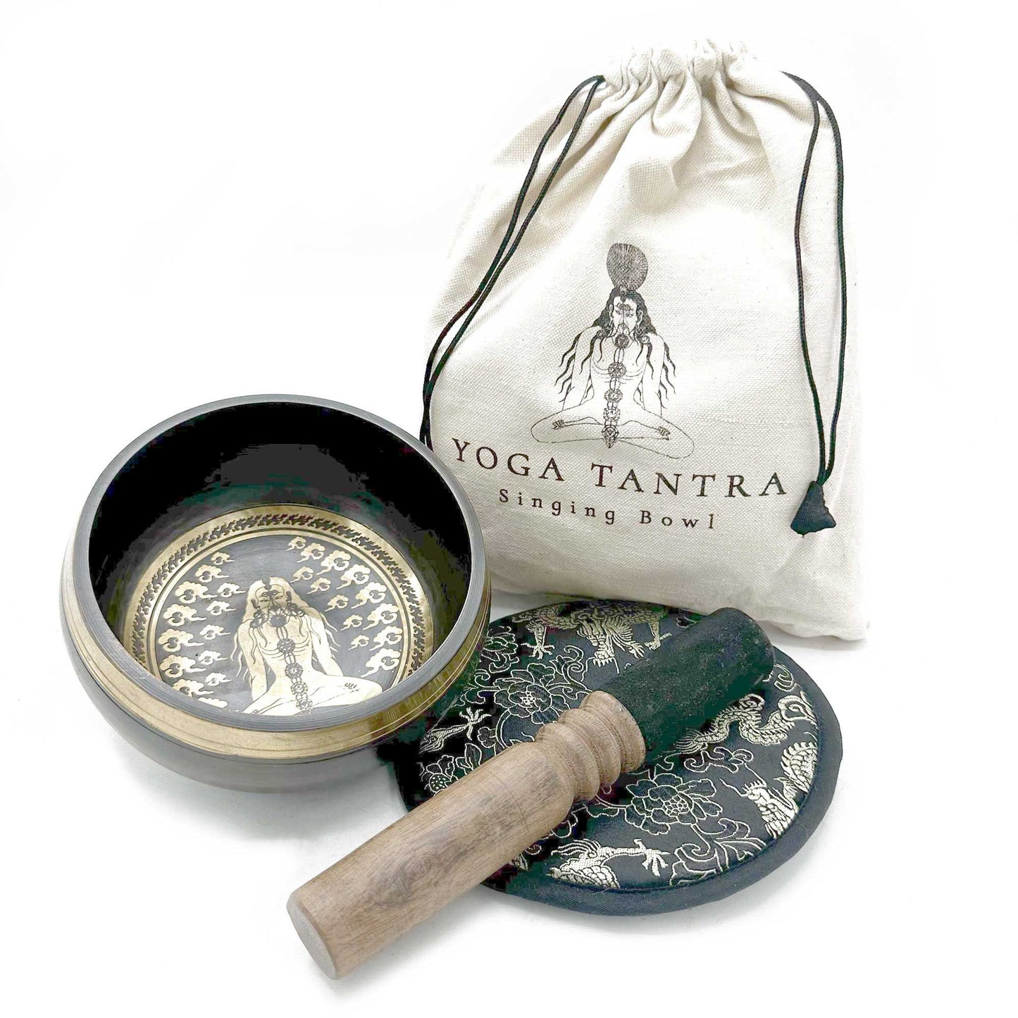 Intricately engraved 14cm hand-beaten singing bowl with a wooden mallet and decorative cushion in a gift pouch.