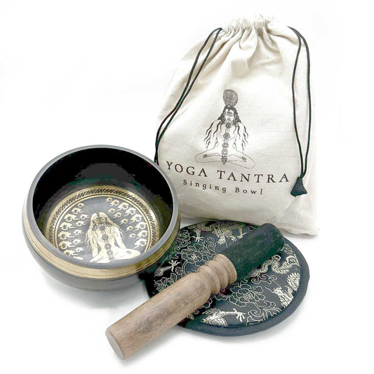 Intricately engraved 14cm hand-beaten singing bowl with a wooden mallet and decorative cushion in a gift pouch.