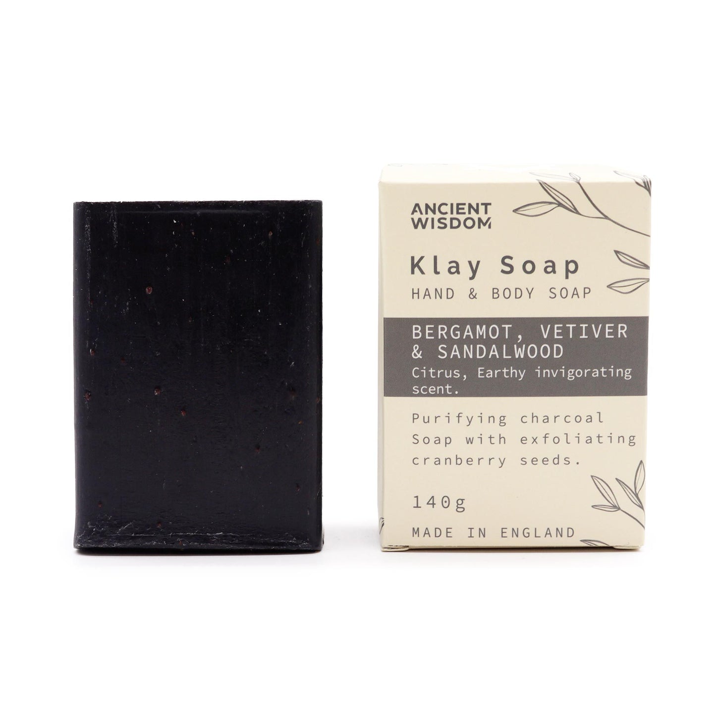 Handcrafted textured soap bar with exfoliating cranberry seeds and dark charcoal swirls on a neutral background.