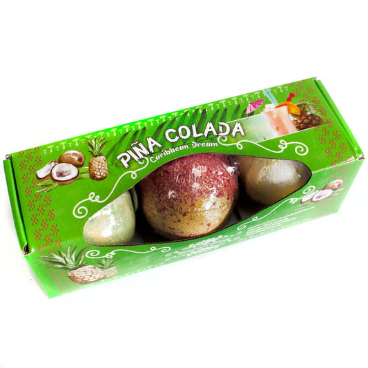 Gift set of three round white bath bombs with yellow speckles inspired by a tropical Piña Colada cocktail.