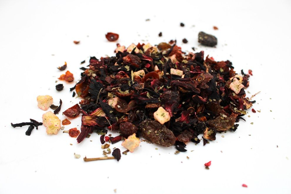 Vibrant red loose leaf artisan tea blend featuring dried blackberries, raspberries, and strawberries in a 1kg bag.