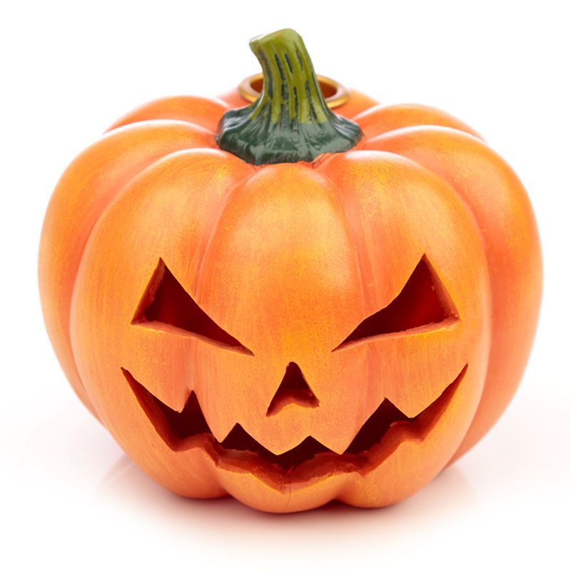 Ceramic orange pumpkin incense burner with a backflow cone releasing a thick white mist through the carved face.