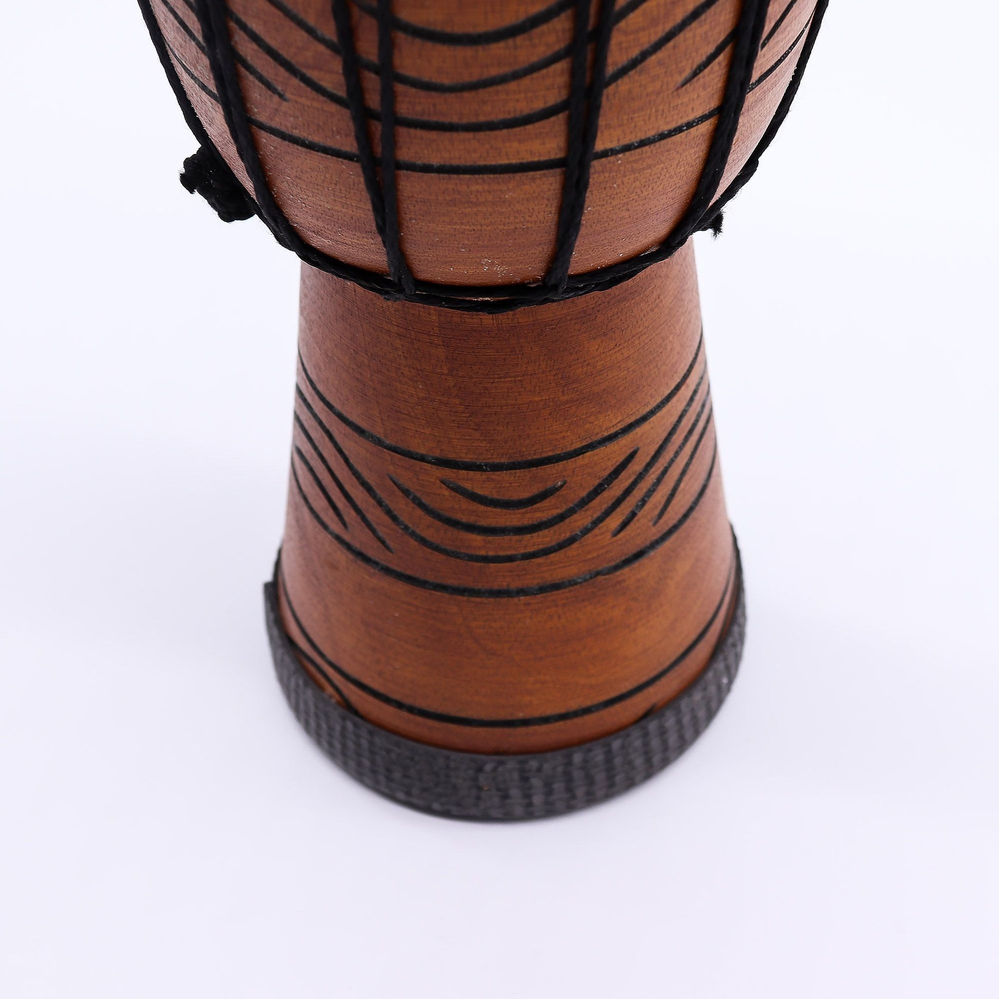 Handcrafted small professional djembe drum with intricate carvings and a natural goat skin head.