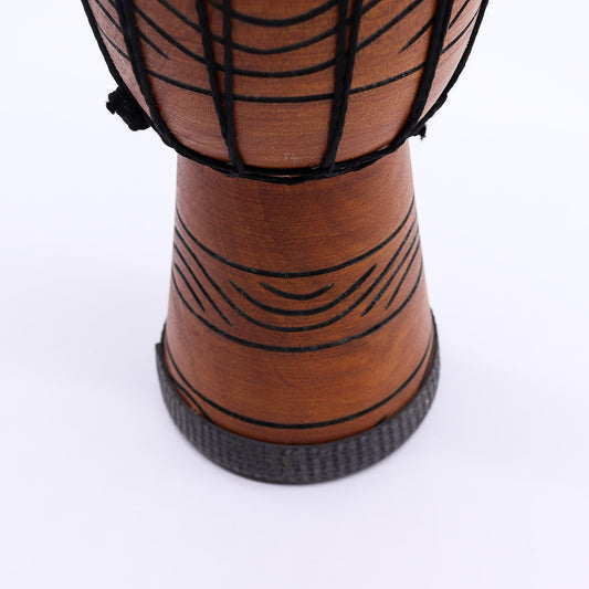 Handcrafted small professional djembe drum with intricate carvings and a natural goat skin head.