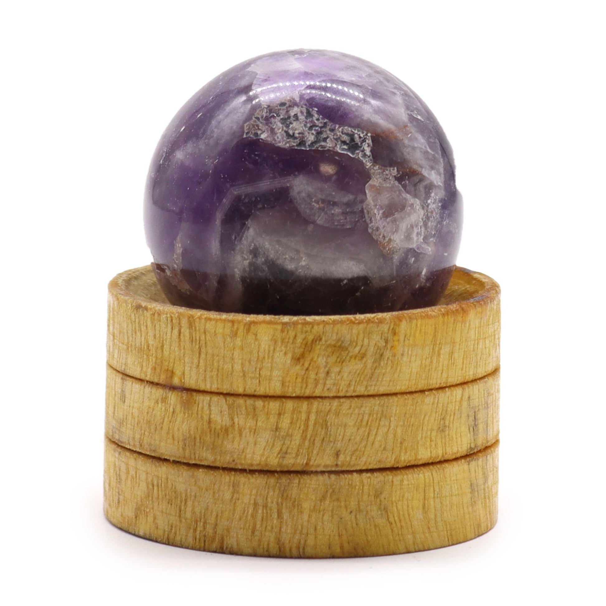 Deep purple African Amethyst crystal sphere, 40mm diameter, displayed on a simple wooden stand.