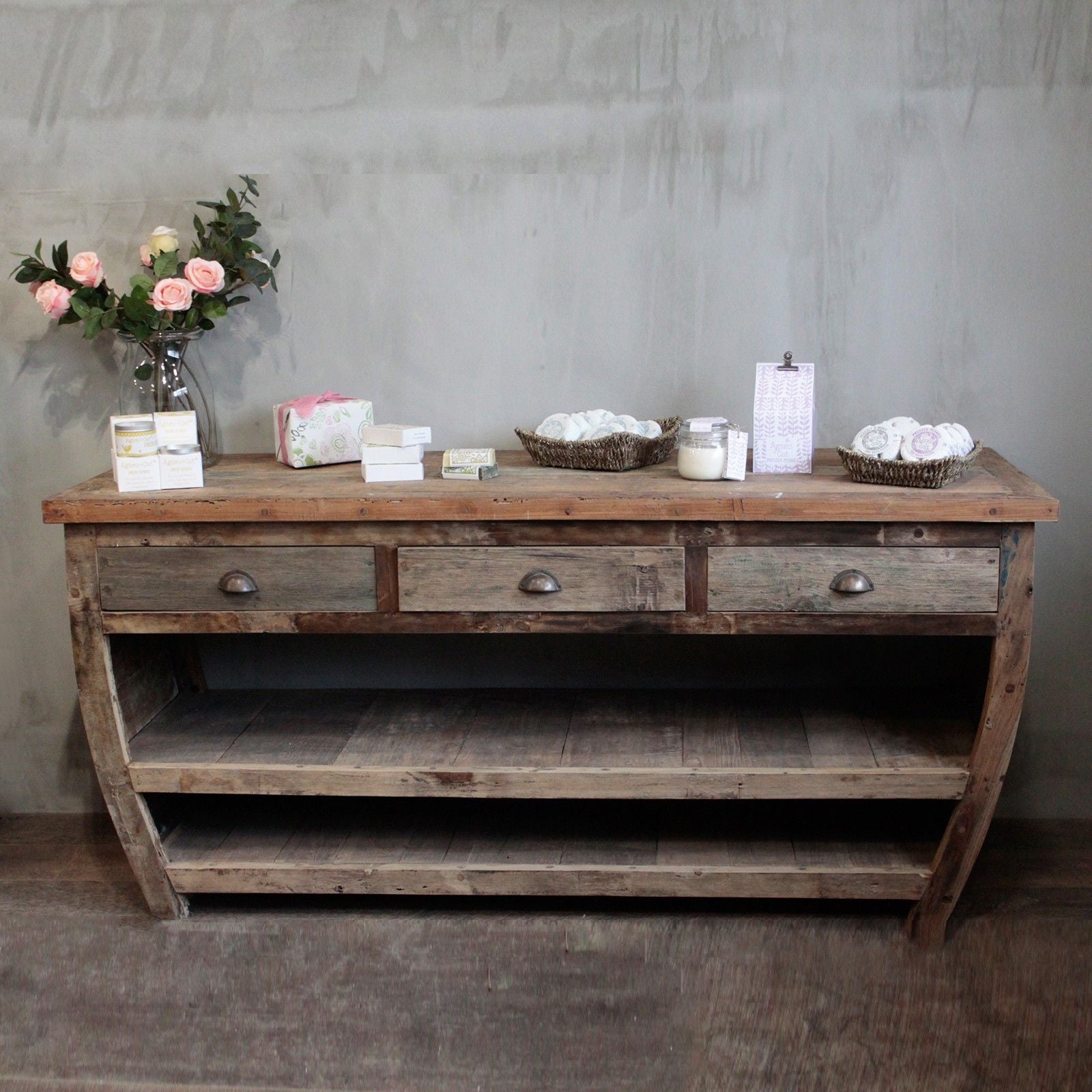 Large hand-made recycled teak wood sideboard table featuring three drawers and two long storage shelves.
