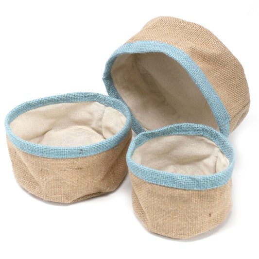 Trio of nesting teal-coloured natural jute storage baskets with a woven texture and white cotton lining.